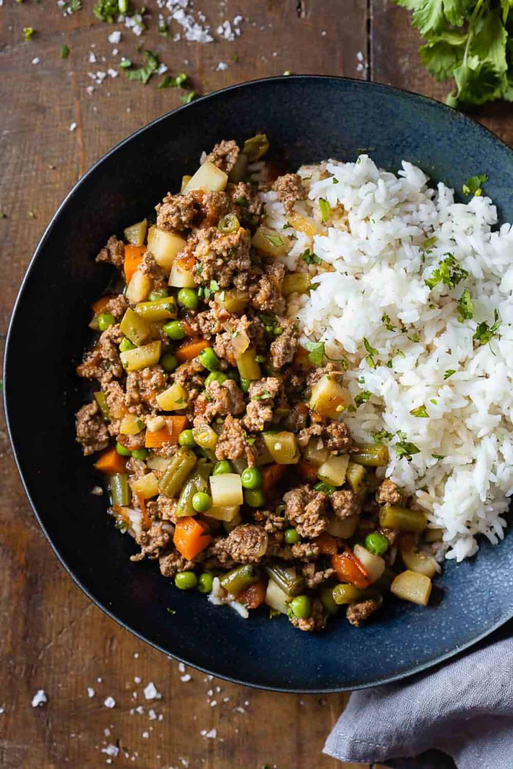 Picadillo and white rice served in a blue bowl.