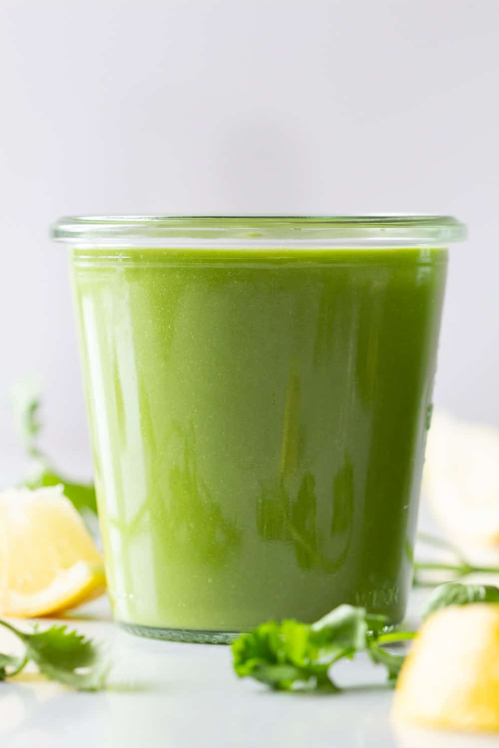 A vibrantly green Keto Smoothie in a glass.