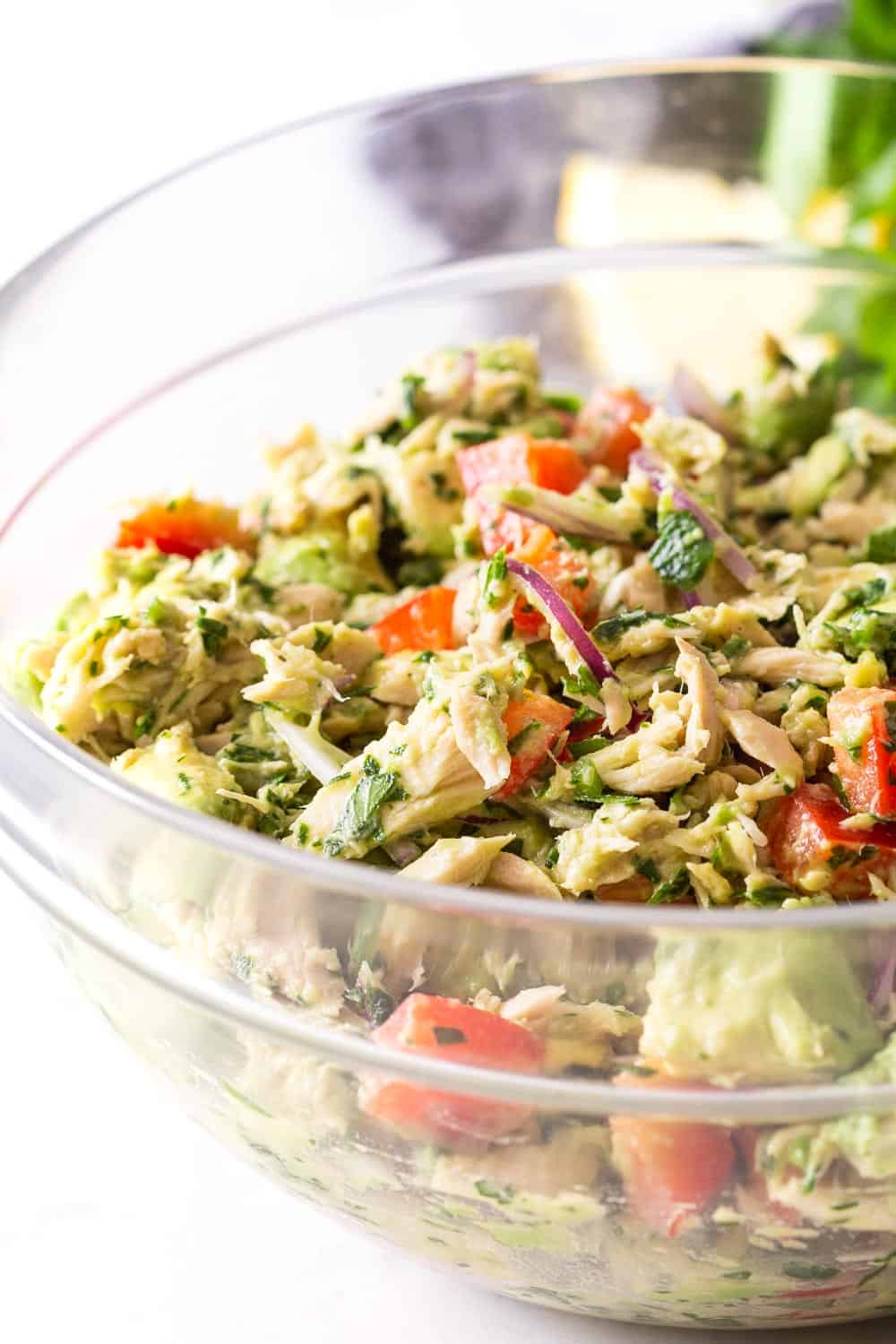 Tuna Avocado Salad all ingredients mixed up in a glass bowl.