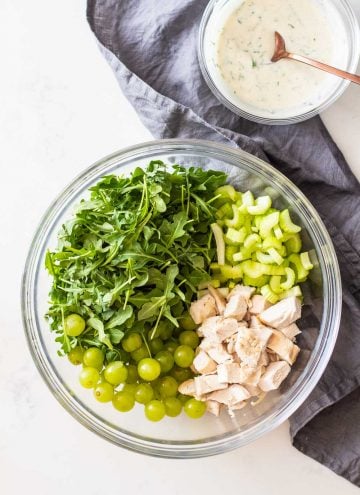 Chicken Salad with Grapes in a large glass bowl with Greek yogurt dressing on the side
