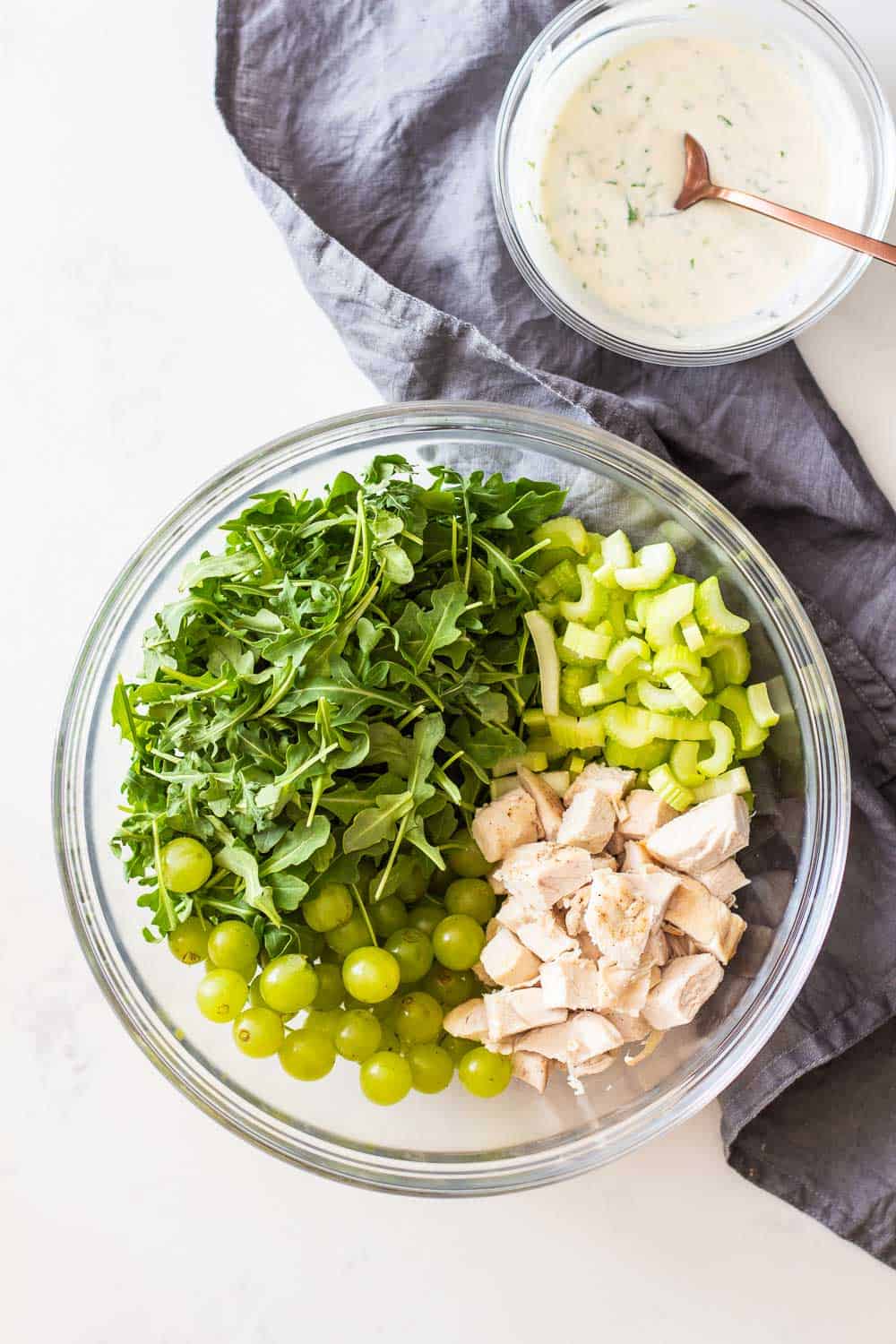 Chicken Salad with Grapes in a large glass bowl with Greek yogurt dressing on the side