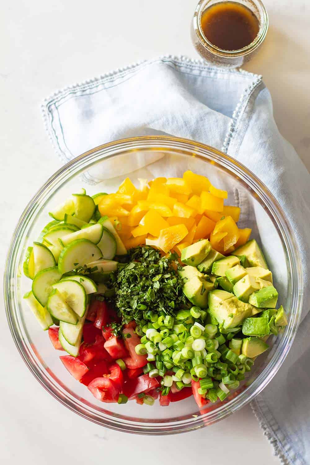 Cucumber Tomato Avocado Salad in a glass bowl.