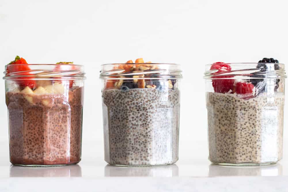 Chia Seed Pudding 3 ways in glass jars one next to the other.