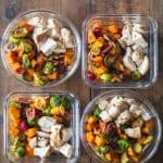 Four Maple Dijon Chicken Meal Prep Bowls on a wooden table.