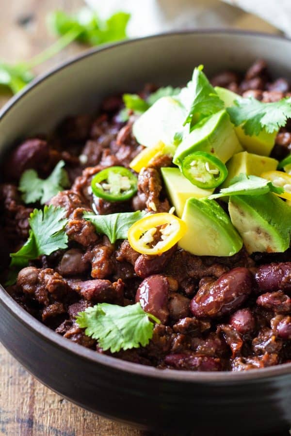 Vegan Instant Pot Chili topped with fresh avocado, cilantro and sliced chili