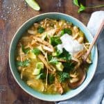 white chicken chili in a a blue bowl on a wooden table