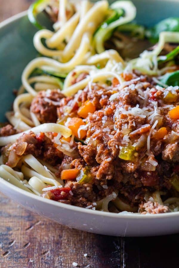 bowl of Slow Cooker Bolognese Sauce over zucchini noodles