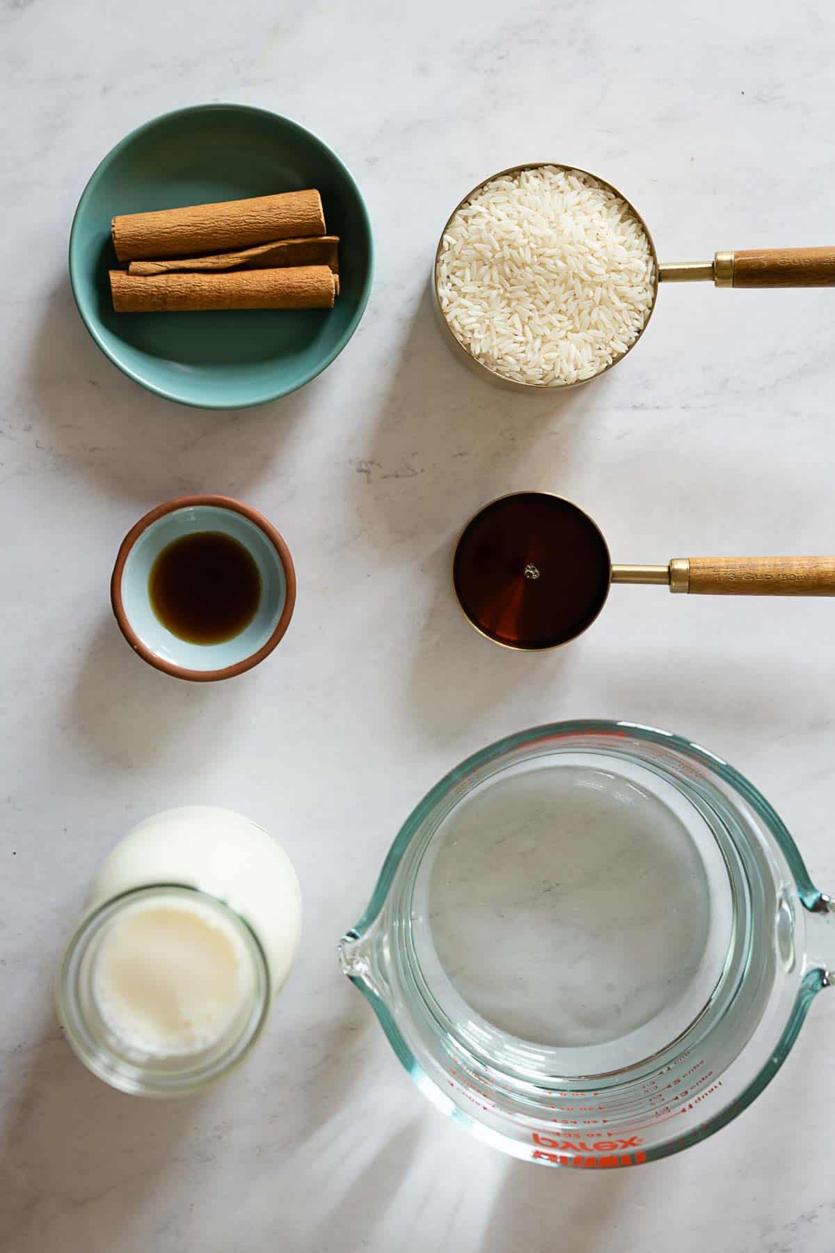 Ingredients to make agua de horchata laid out on a kitchen counter.