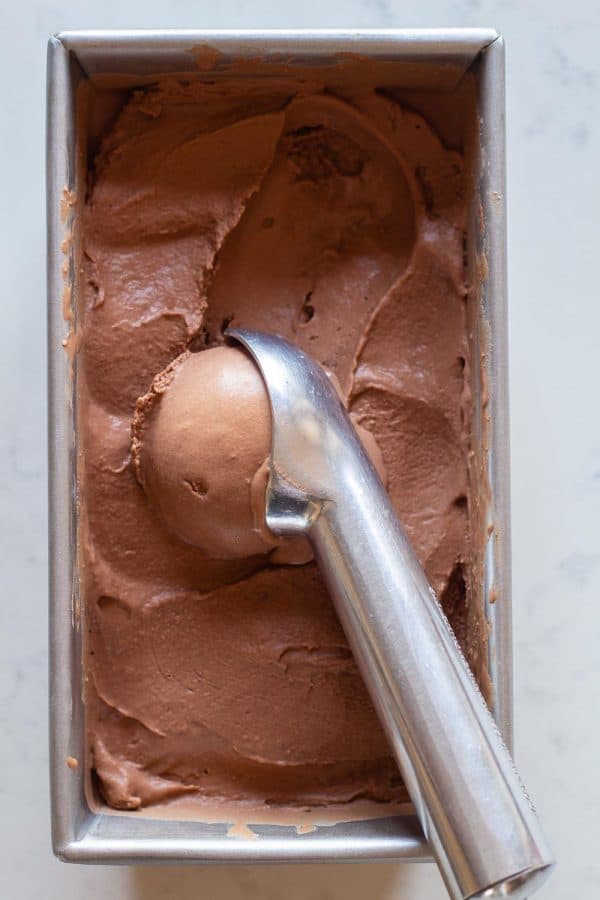 Chocolate Peanut Butter Ice Cream in a container scooped out with an ice cream scoop