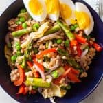 Farro Spring Salad in a bowl with hard boiled eggs on top