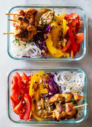 Chicken Satay with Peanut Sauce and sliced raw vegetables and rice noodles in meal prep containers