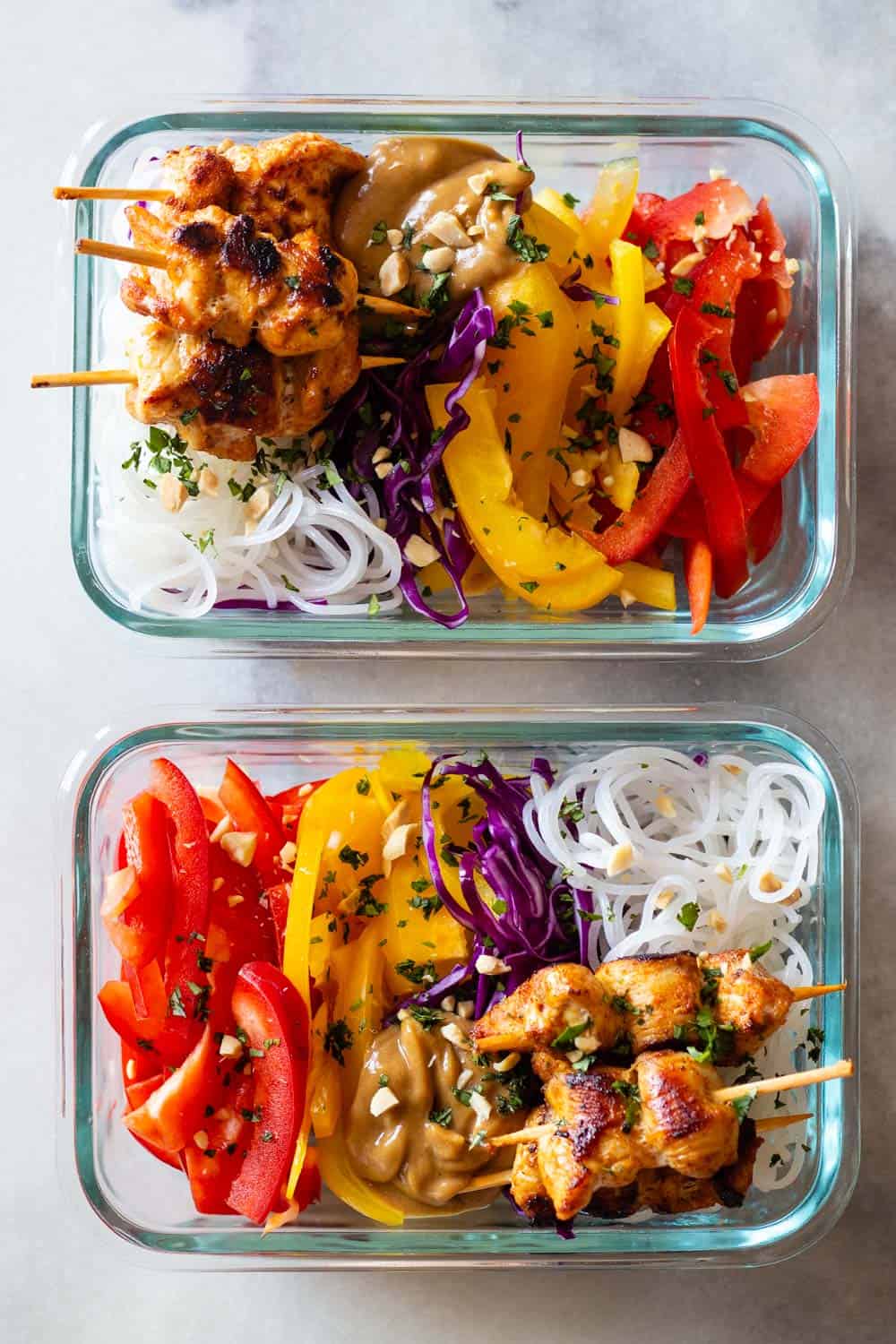 Chicken Satay with Peanut Sauce and sliced raw vegetables and rice noodles in meal prep containers