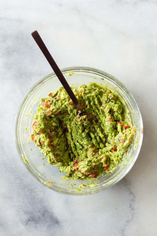 Guacamole mushed with a fork in a bowl