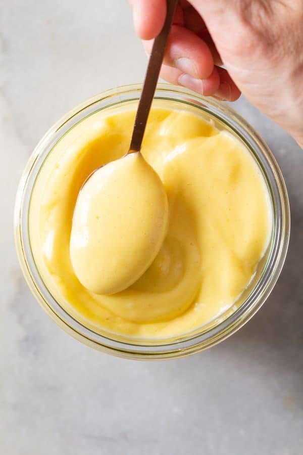 spoon of thick and creamy Hollandaise Sauce