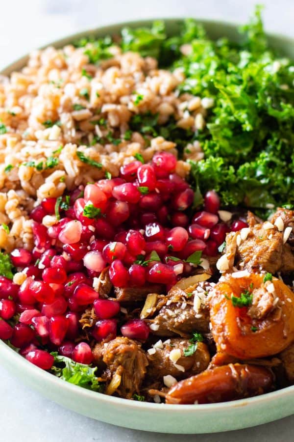 big bowl of farro salad with kale and pomegranate seeds