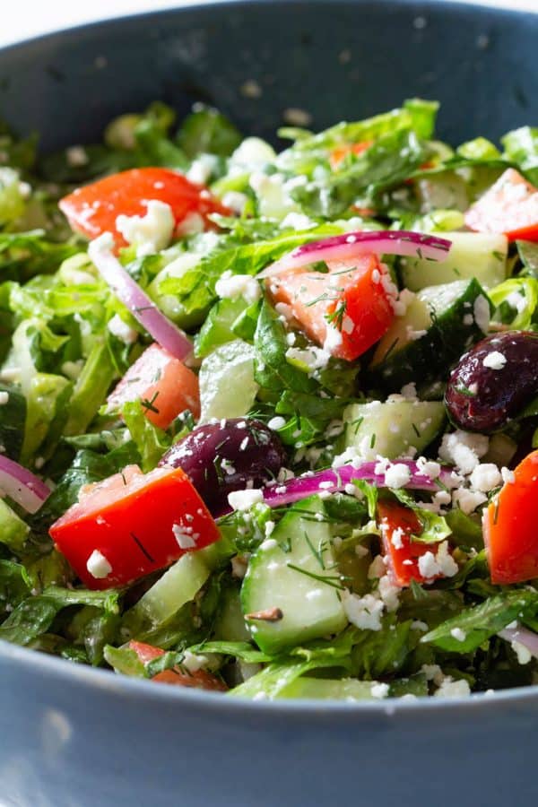 Healthy salad with cucumber tomato onion and feta cheese
