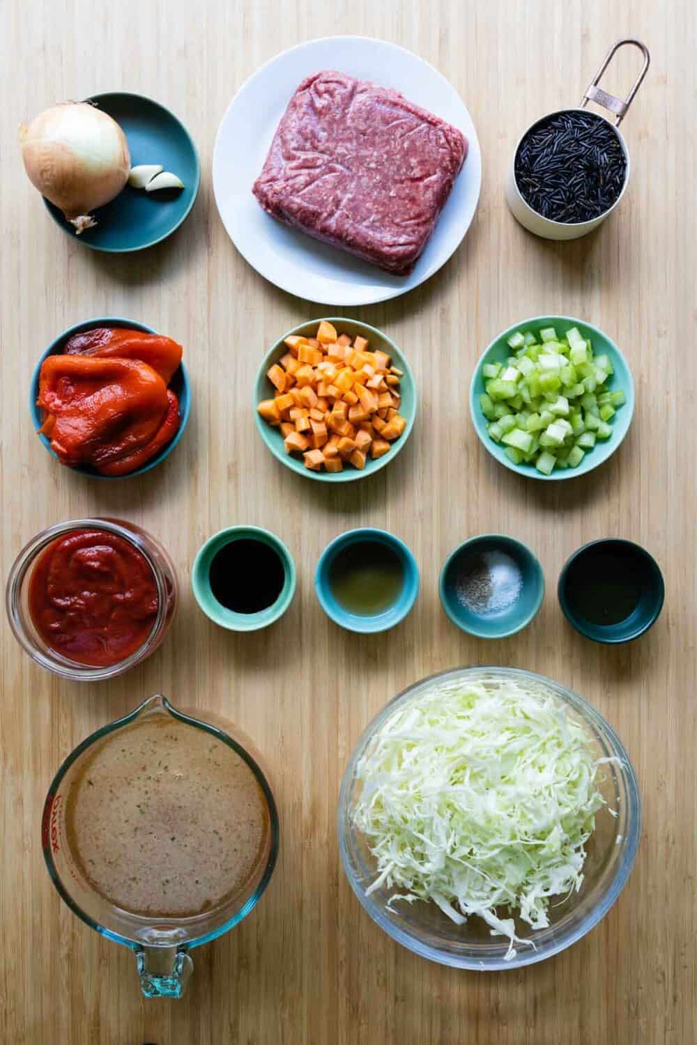 Ingredients for cabbage roll soup laid out on a kitchen counter.