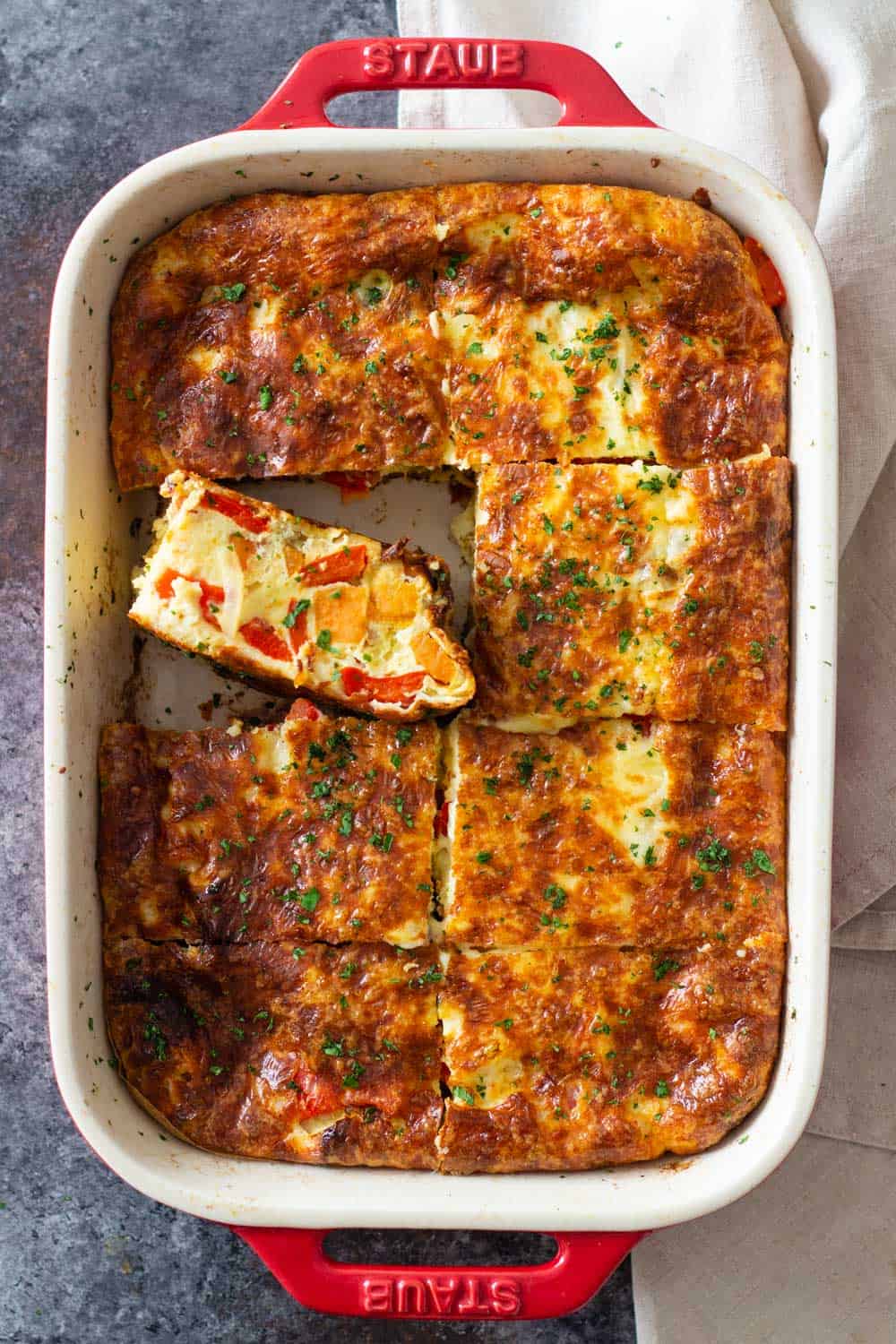 Sweet potato breakfast casserole in a red baking dish