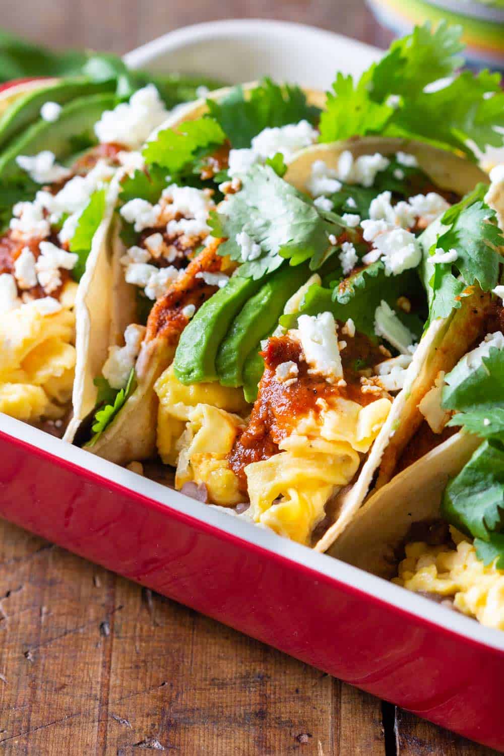 Closeup of Breakfast Tacos with scrampled eggs and avocado and salsa and cilantro as toppings