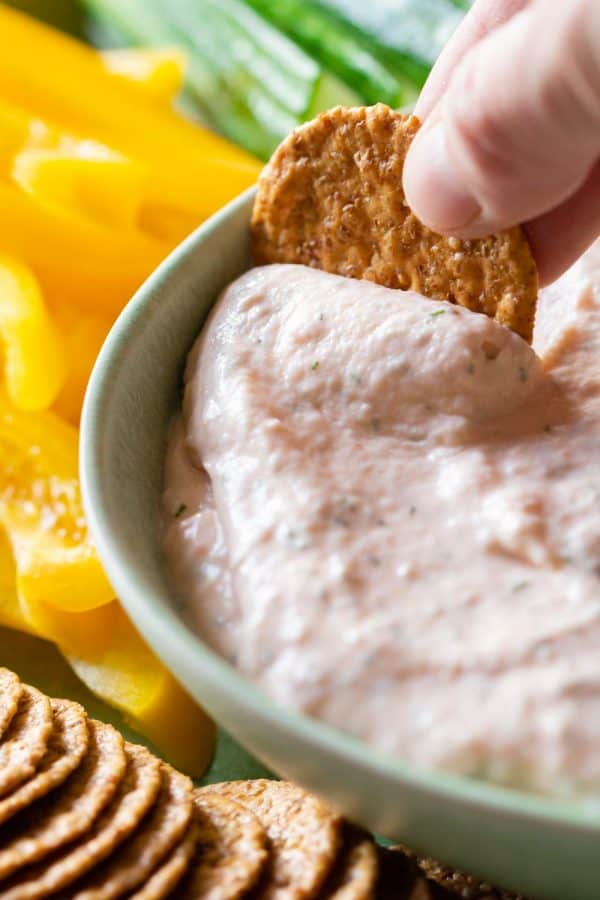 Closeup of cracker dipped in smoked salmon dip