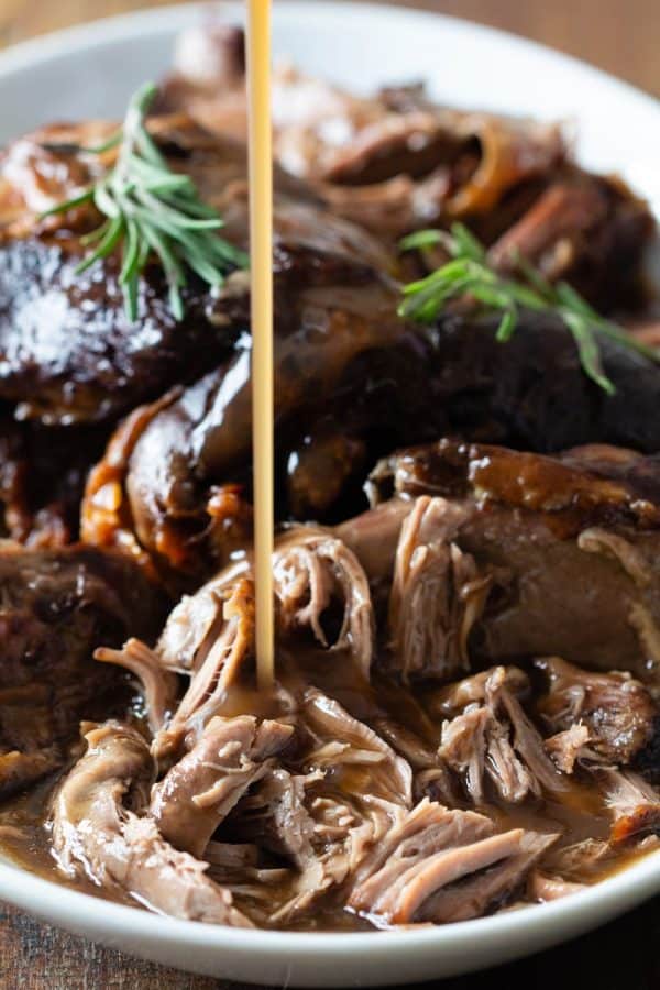 Gravy poured over shredded leg of lamb