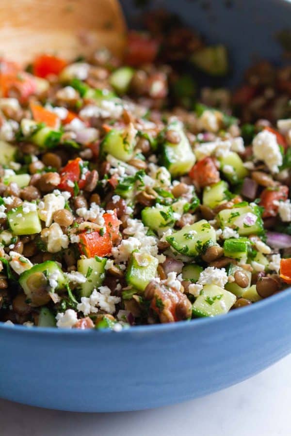 mixed up lentil salad in a blue bowl