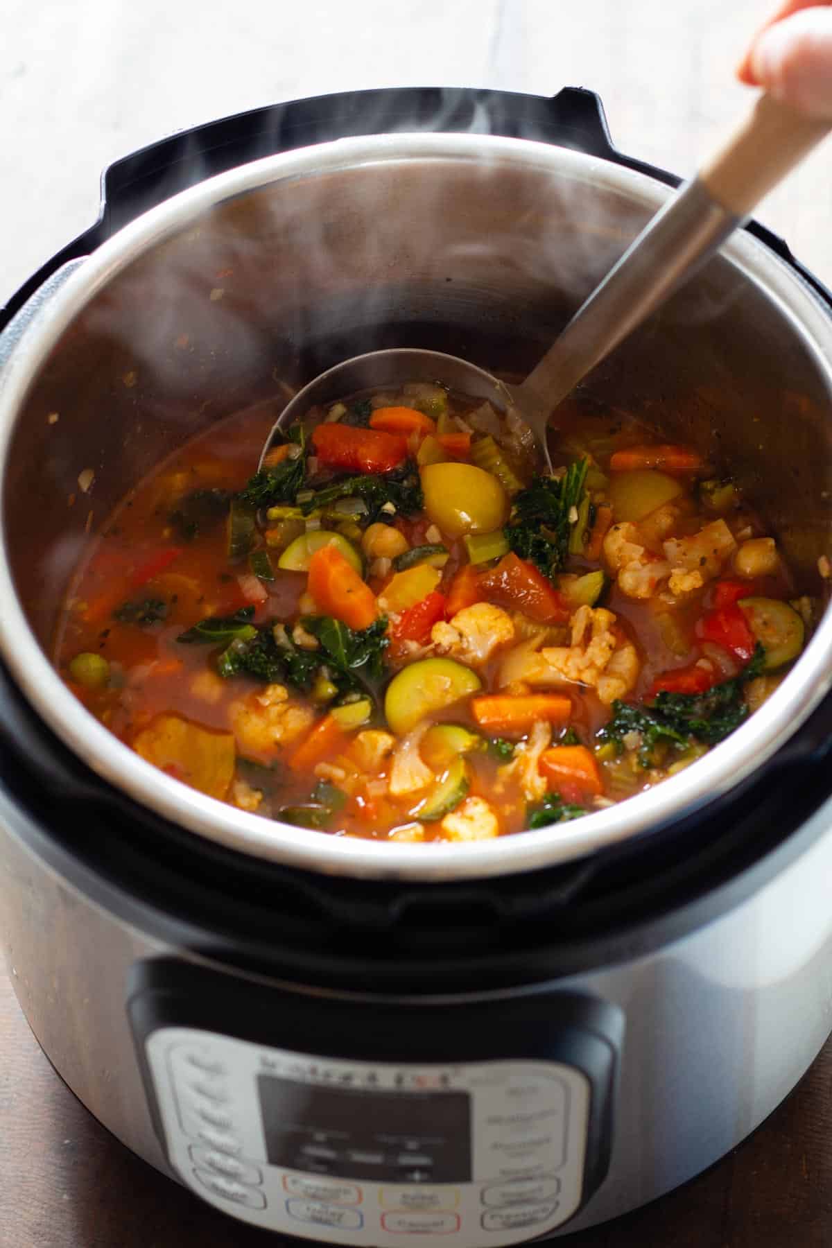 Vegetable Soup in an Instant Pot with a ladle in it