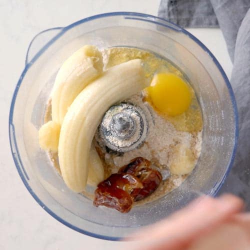 oat flour, bananas, dates, and an egg in a food processor