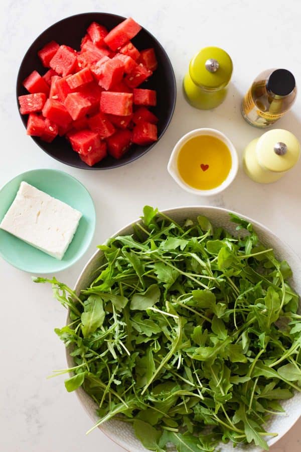 Ingredients for Watermelon Arugula Salad showcased one next to the other