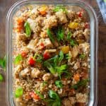 Quinoa fried rice in a glass meal prep container.
