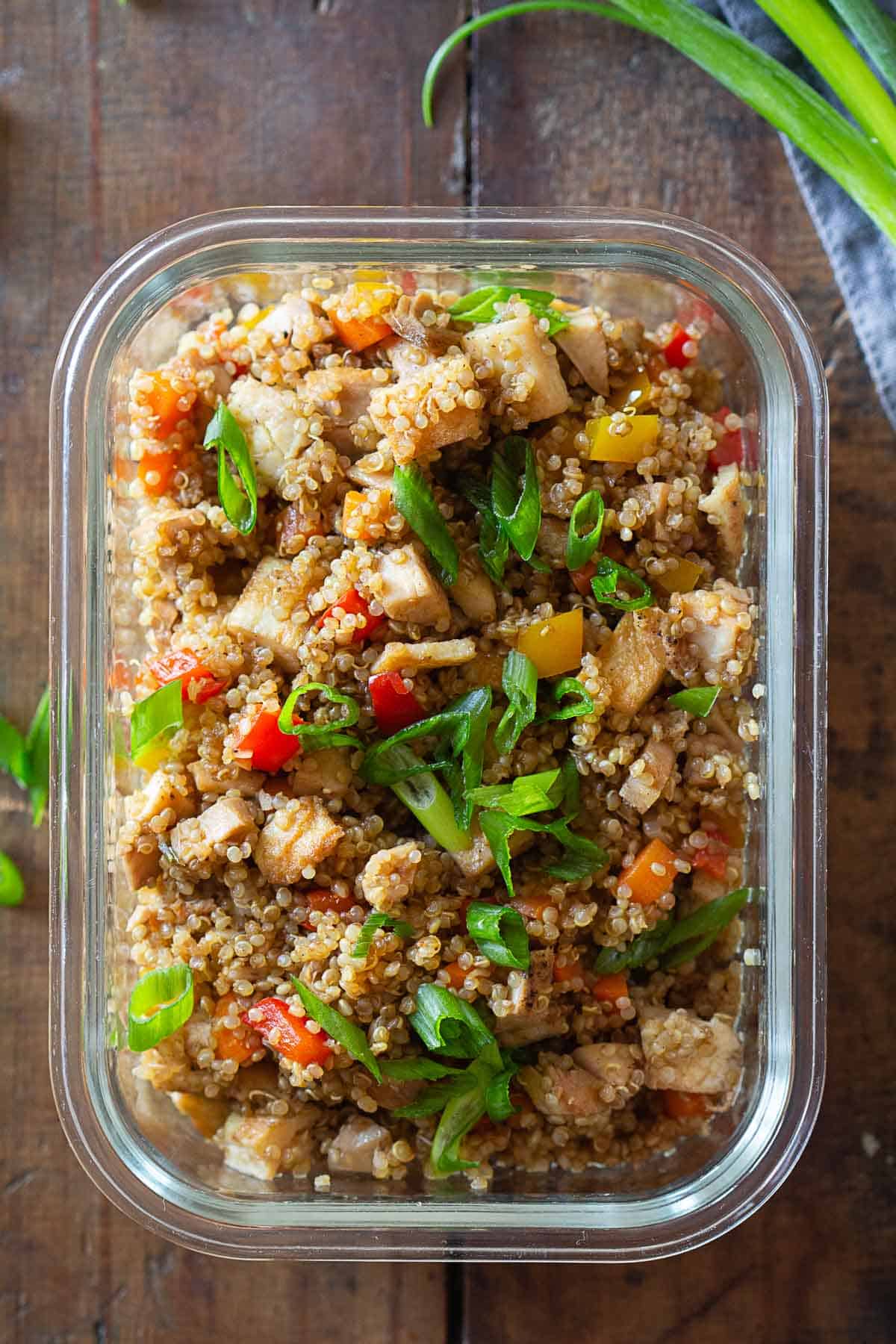Quinoa fried rice in a glass meal prep container.