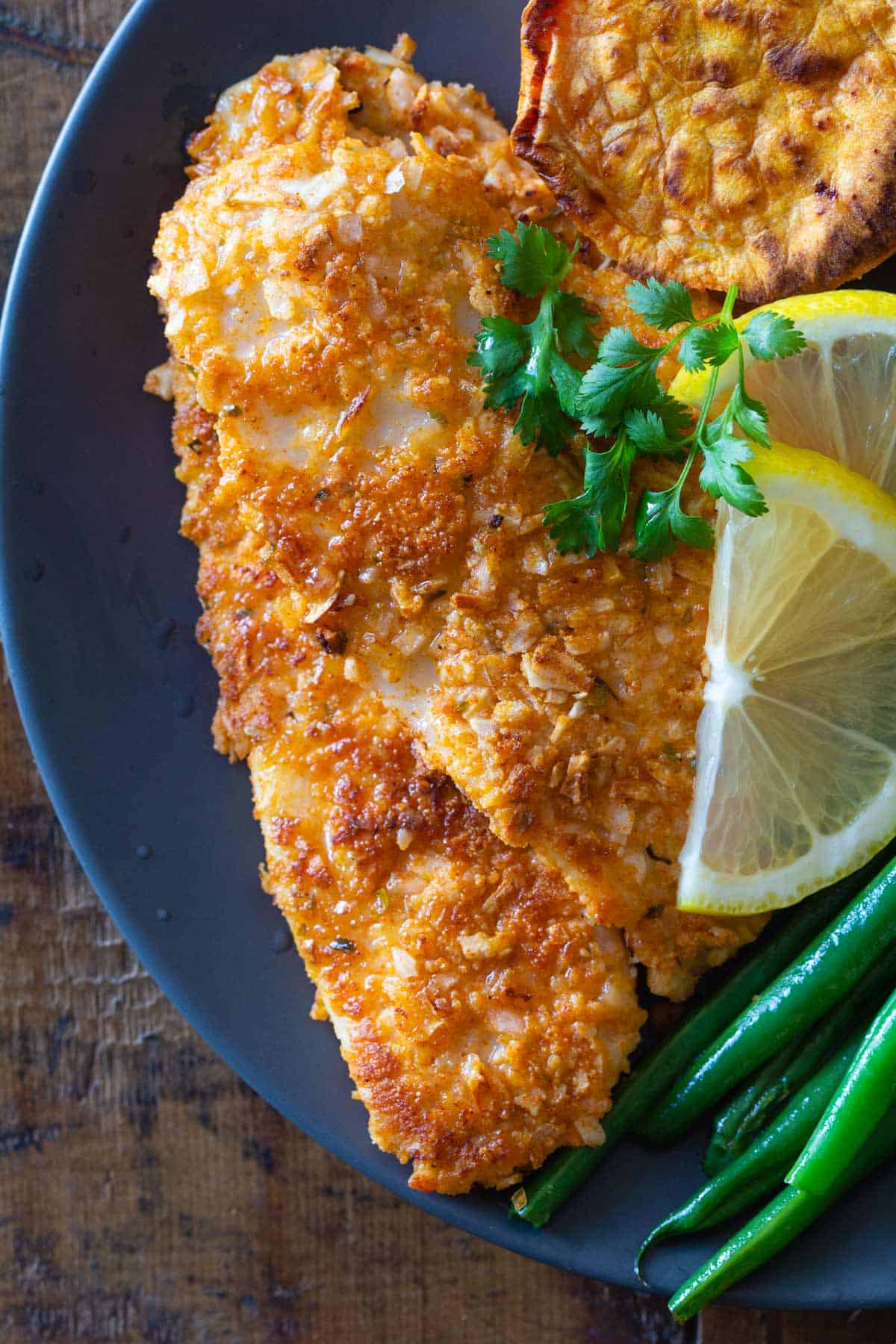 Breaded sole fish fillet on a plate.