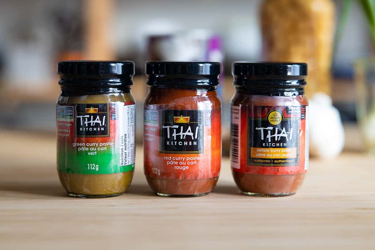 3 jars of Thai curry paste: green, red, and yellow.