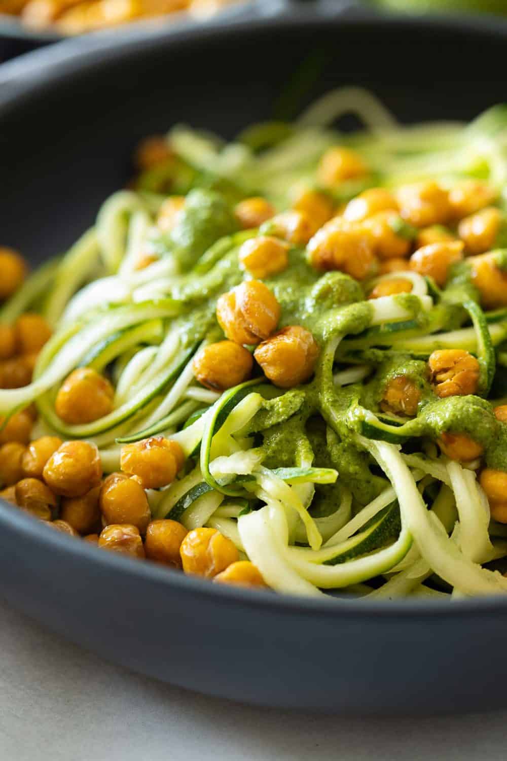 Closeup texture of zucchini noodles and chickpeas.