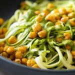 Closeup texture of zucchini noodles and chickpeas.