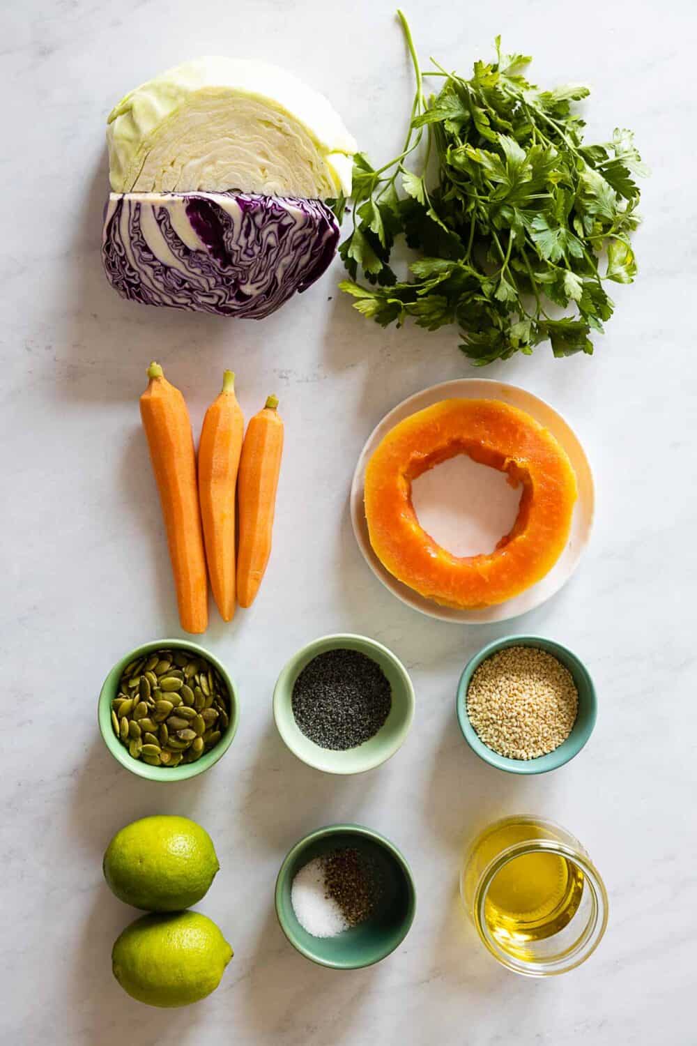 Ingredients for a healthy coleslaw all laid out on a kitchen counter.