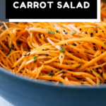 Carrot salad in a blue salad bowl with text overlay for Pinterest.
