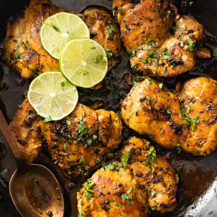 Closeup shot of texture of cooked cilantro lime chicken thighs in a pan.