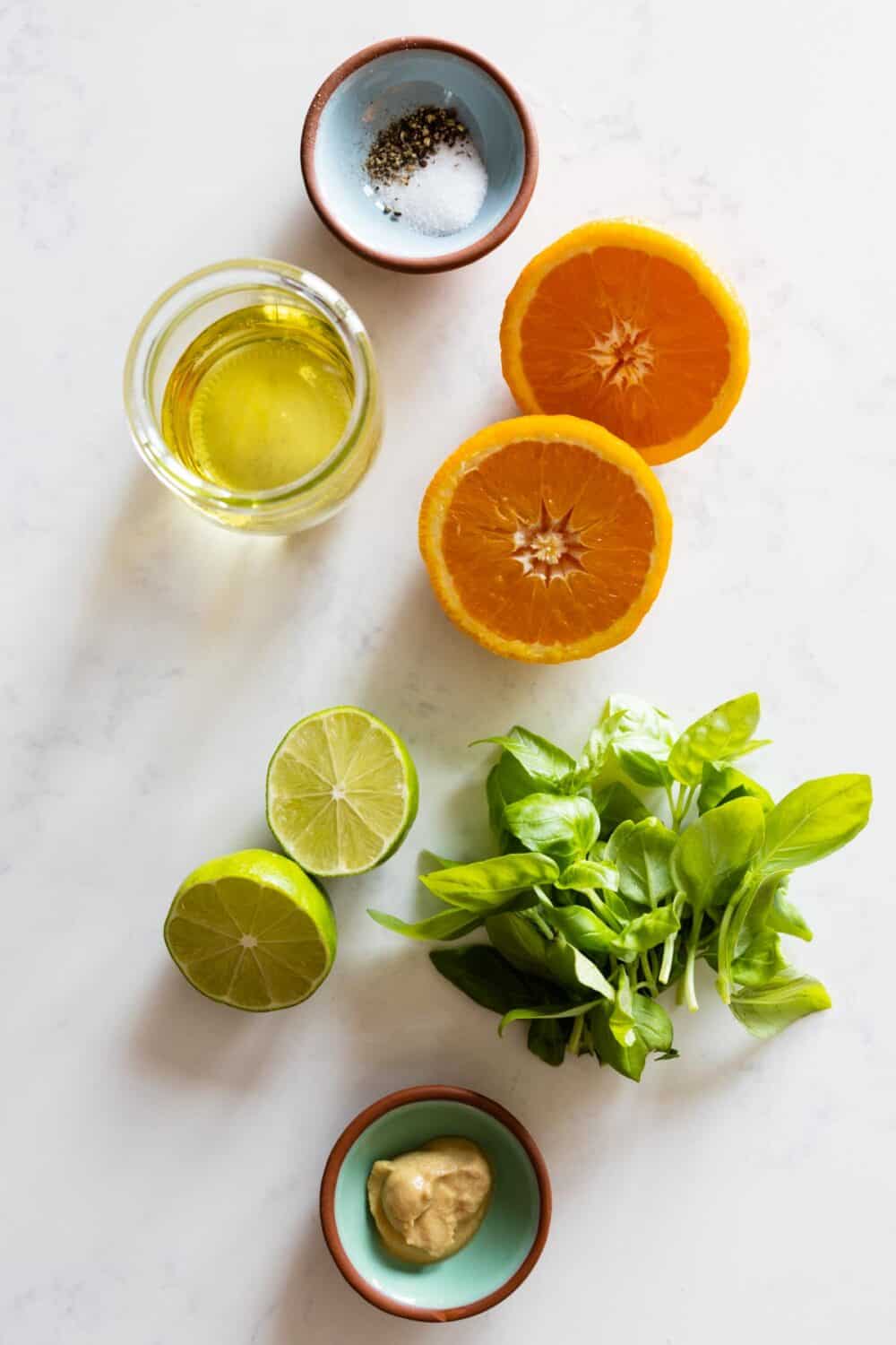 Ingredients for Citrus Basil Dressing laid out on a kitchen counter.
