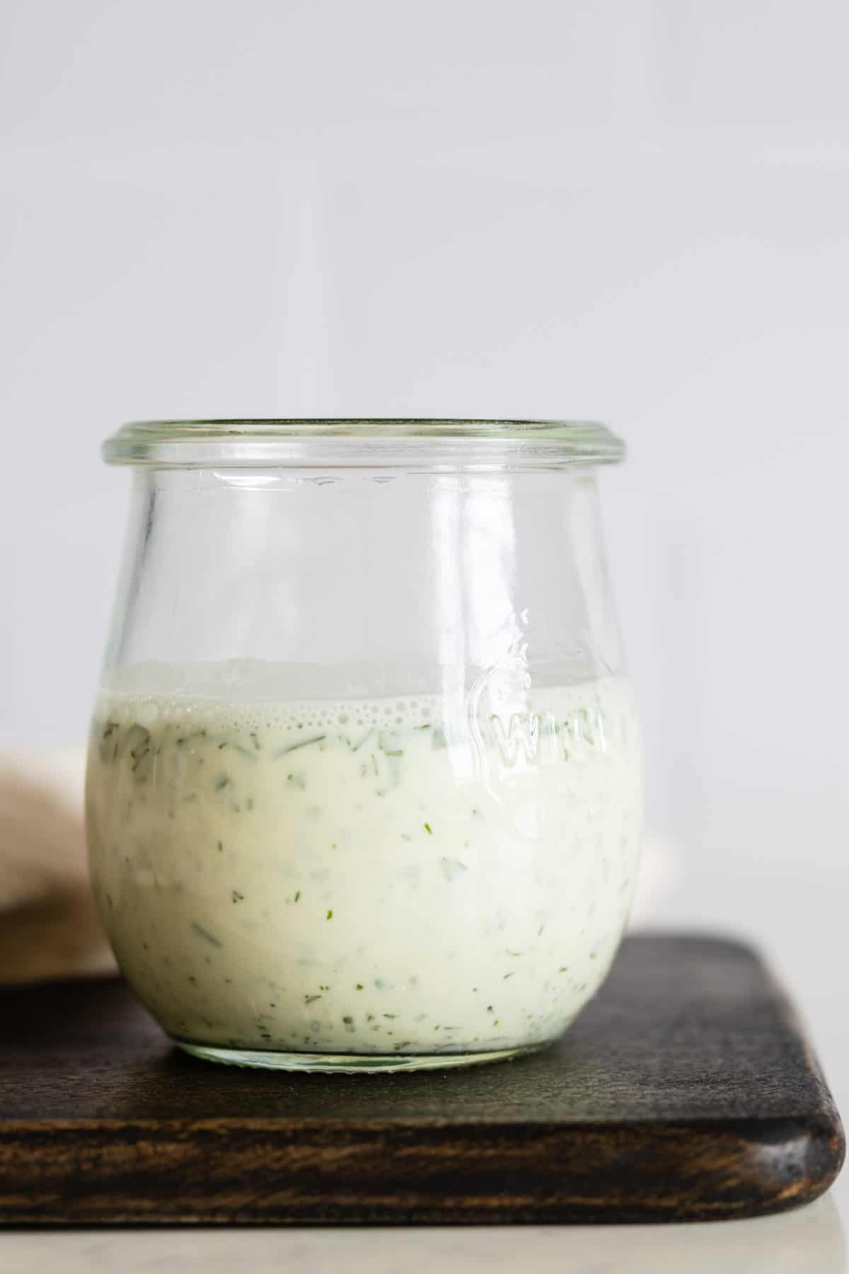 Greek Yogurt Herb Dressing in a glass jar.