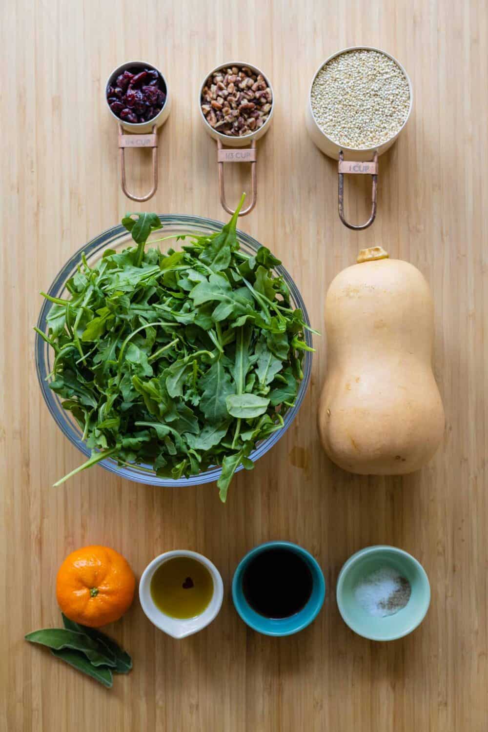 Ingredients for butternut squash salad laid out on a kitchen counter.