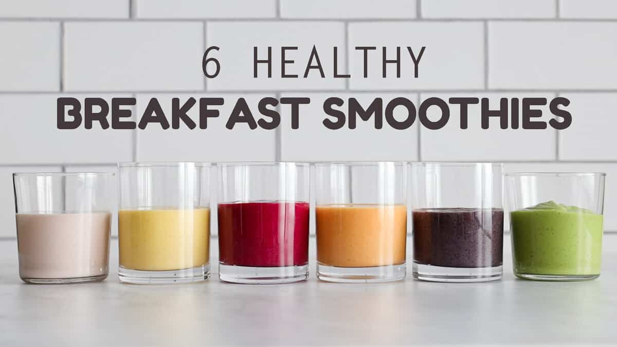 6 breakfast smoothies of different colors lined up next to each other.