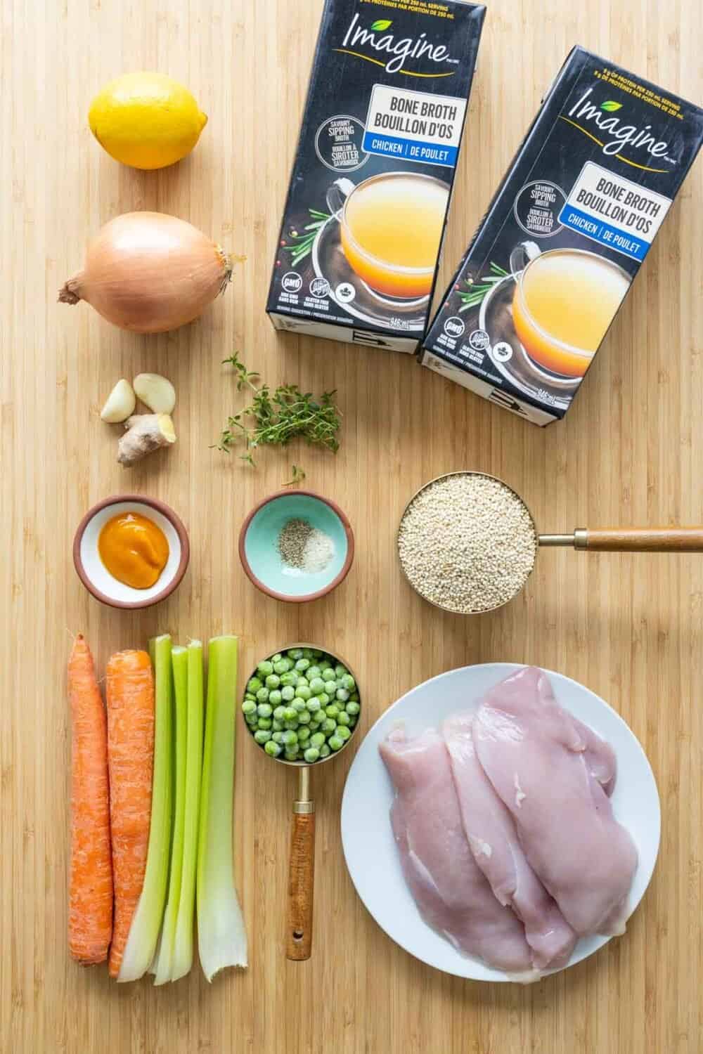 Ingredients for chicken soup laid out on a kitchen counter.