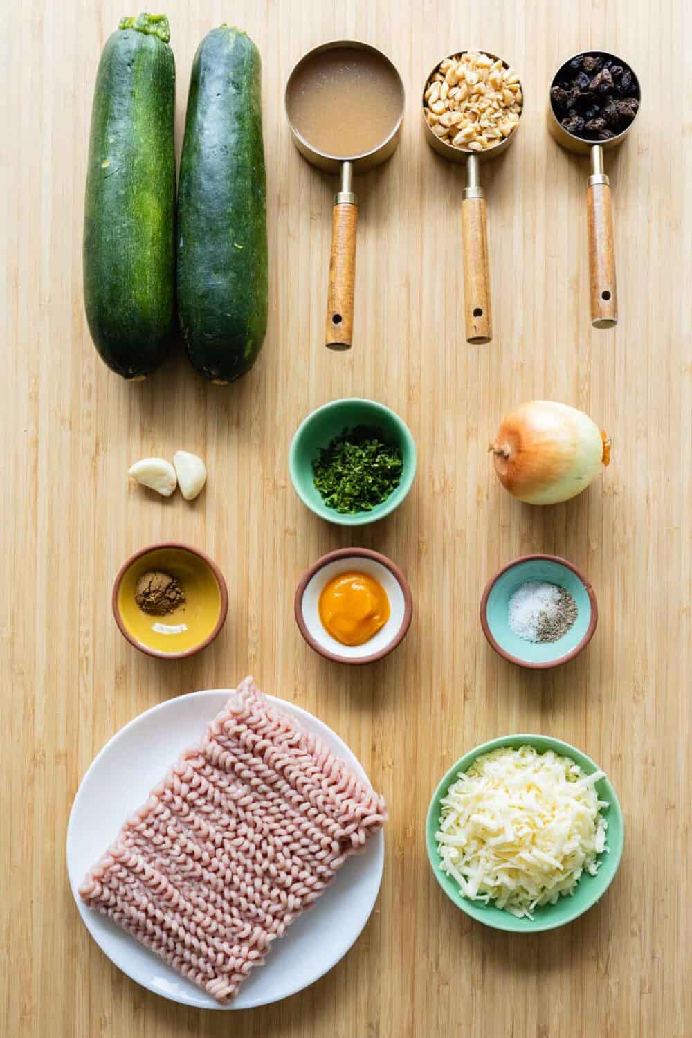 Ingredients for Stuffed Zucchini boats laid out on a kitchen counter.