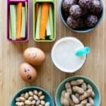 after-school snacks in bowls and containers laid out on a kitchen counter.