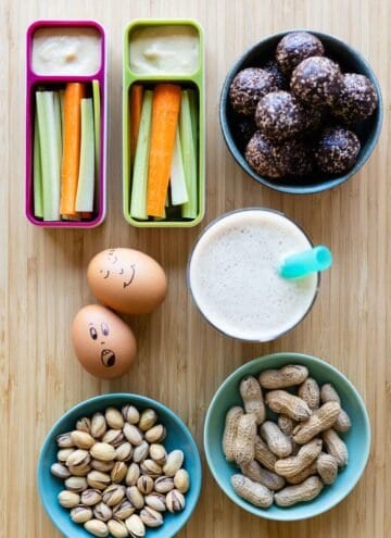 after-school snacks in bowls and containers laid out on a kitchen counter.