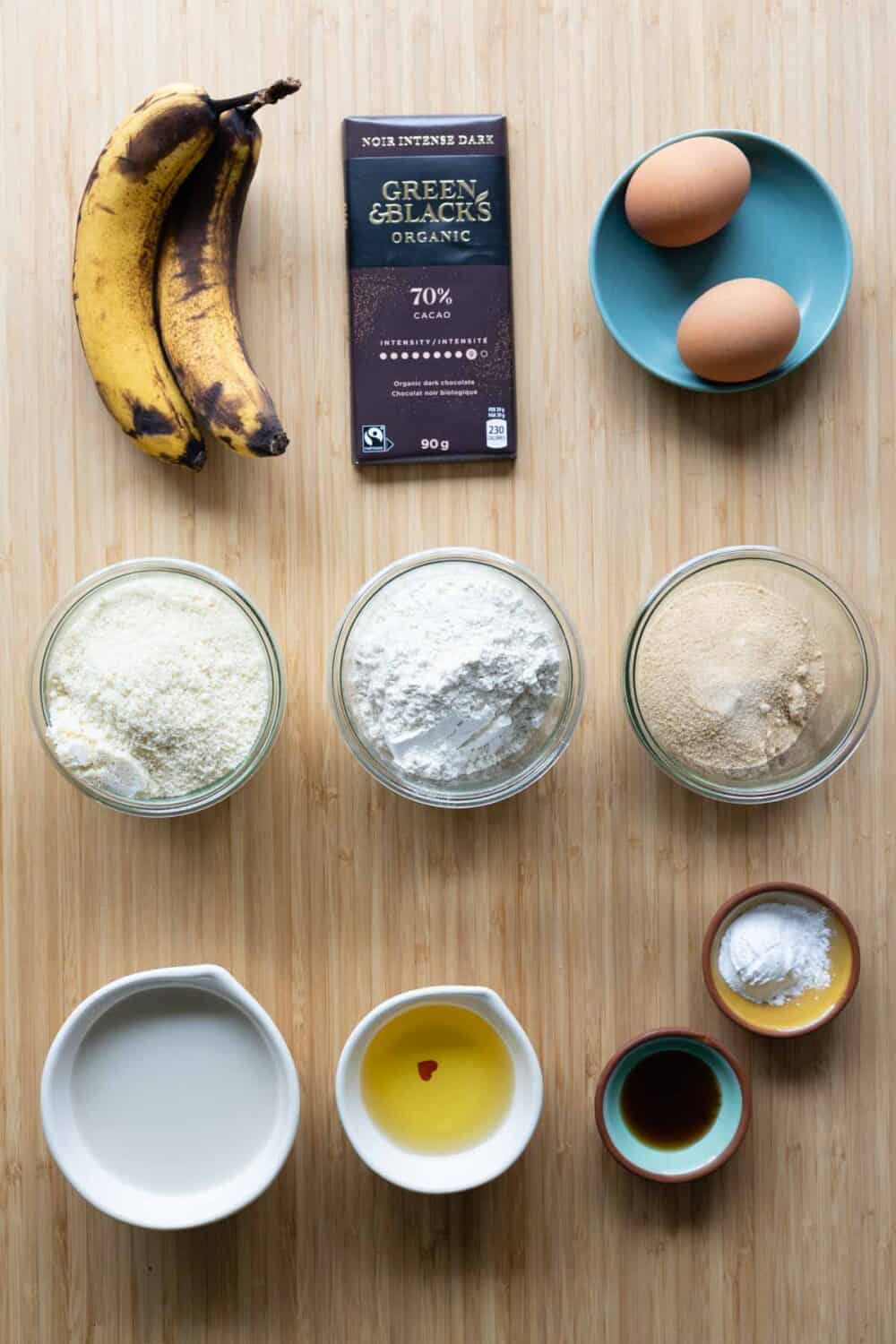 Ingredients for healthy banana muffins laid out on a kitchen counter.
