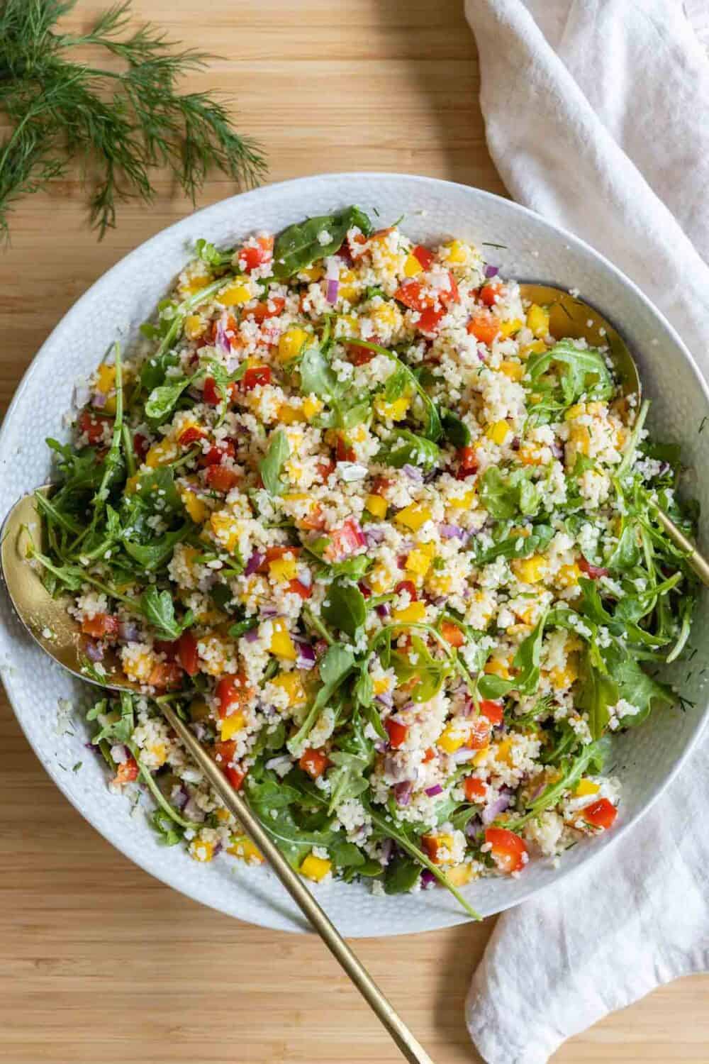 Couscous salad in a salad bowl shown from birds-eye view.