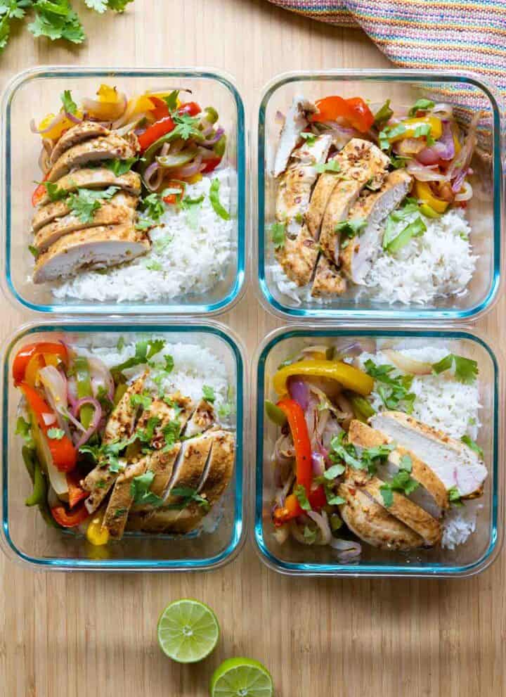 Four meal prep bowls filled with chicken fajitas and rice.