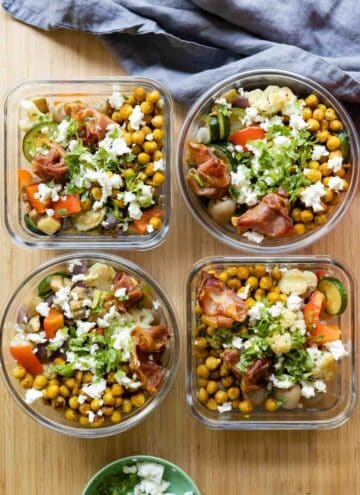 Four meal prep containers filled with chickpeas and vegetables.